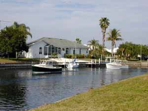 A parade of boats by homes in Burnt Store Isles